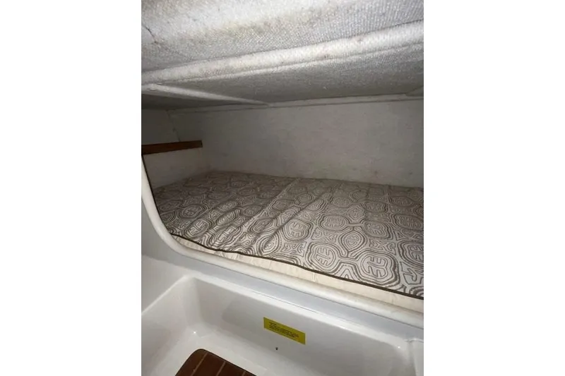 Slide: The Image of 1997 Pursuit 2870 Walkaround cabin interior with patterned bedding. - 18