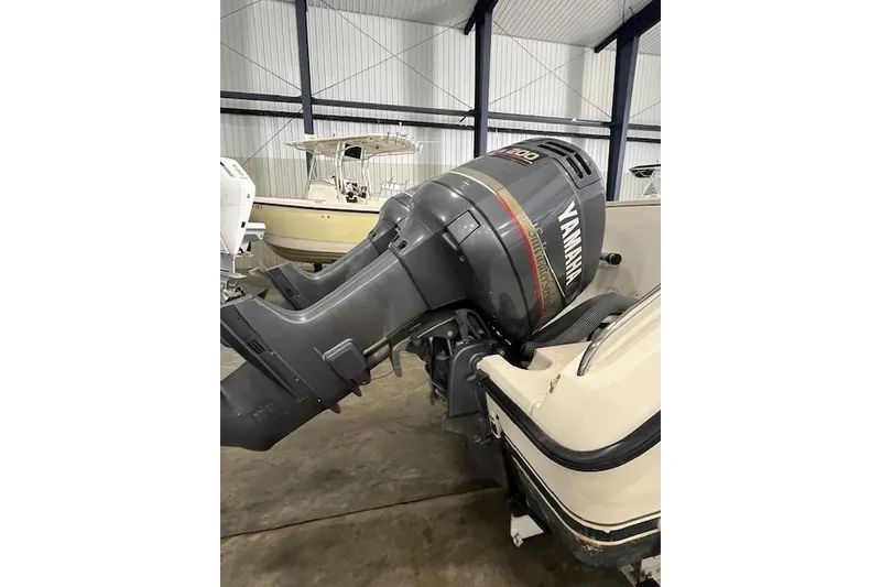 Slide: The Image of 1997 Pursuit 2870 Walkaround with Yamaha outboard motor in a storage facility. - 22