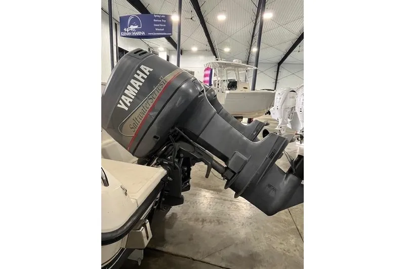 Slide: The Image of 1997 Pursuit 2870 Walkaround with Yamaha Saltwater Series outboard motor in a marina. - 23