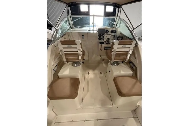 Slide: The Image of 1997 Pursuit 2870 Walkaround boat interior with dual seats and steering console. - 4