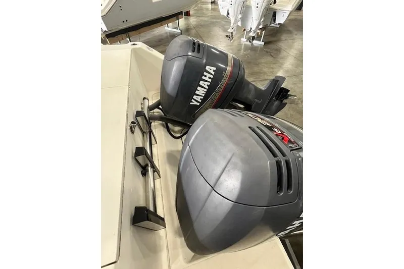 Slide: The Image of Twin Yamaha outboard motors on a 1997 Pursuit 2870 Walkaround boat in a showroom. - 9
