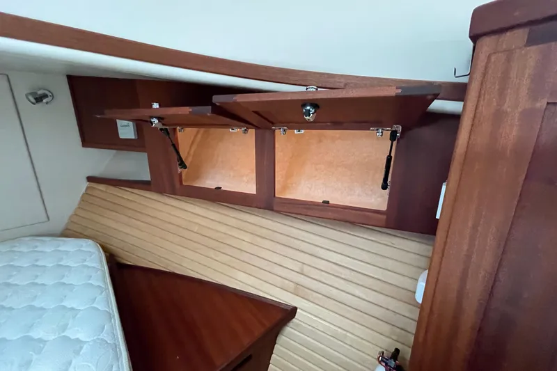 Slide: The Image of Interior of 2013 American Tug 395 showing wooden cabinetry and storage compartments. - 100