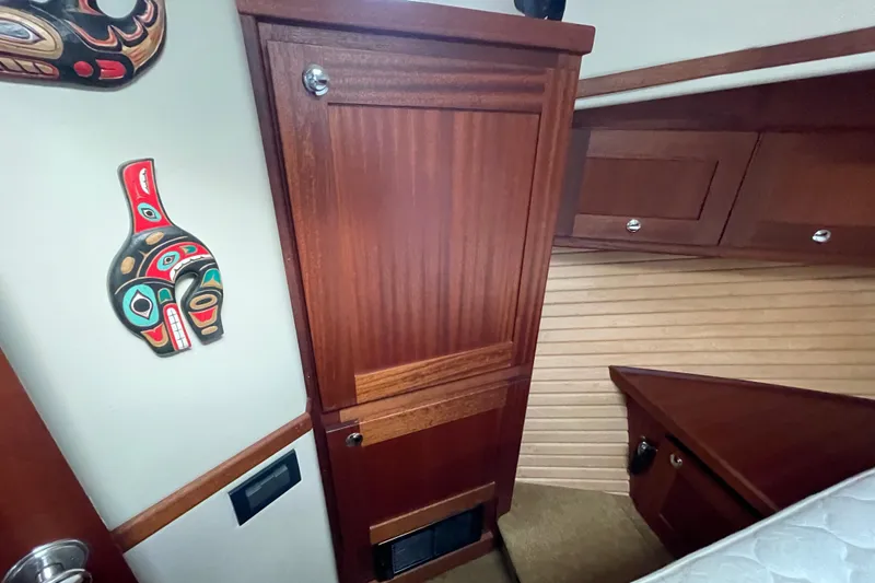 Slide: The Image of Interior of 2013 American Tug 395 with wooden cabinetry and decorative wall art. - 102