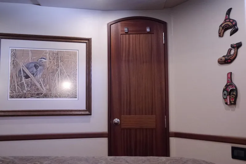 Slide: The Image of Interior of 2013 American Tug 395 with framed bird art and decorative wall masks. - 103