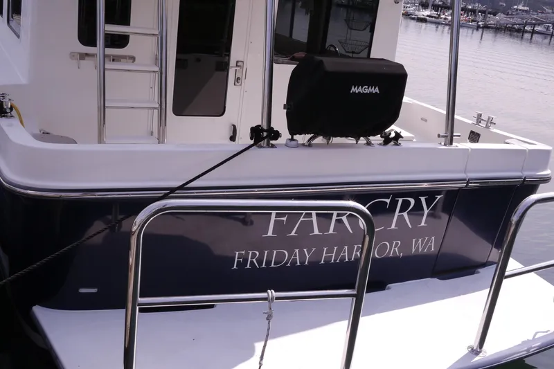 Slide: The Image of 2013 American Tug 395 docked at Friday Harbor, WA, with visible deck and grill. - 104