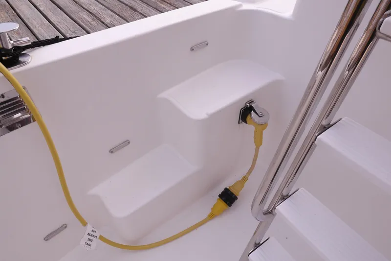 Slide: The Image of 2013 American Tug 395 boat with yellow power cable and white steps. - 109