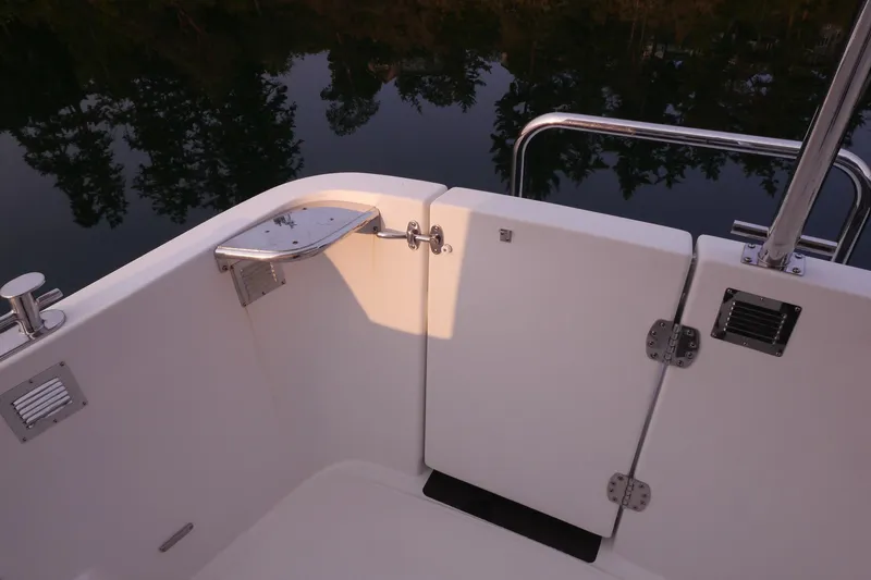 Slide: The Image of 2013 American Tug 395 boat deck with railing and water reflection. - 110