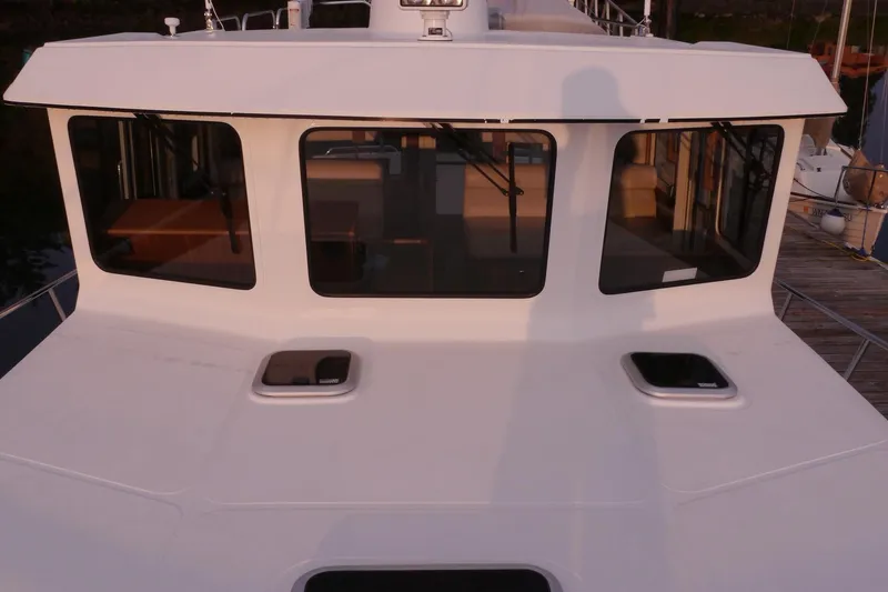 Slide: The Image of 2013 American Tug 395 boat exterior with large windows and deck hatches. - 113