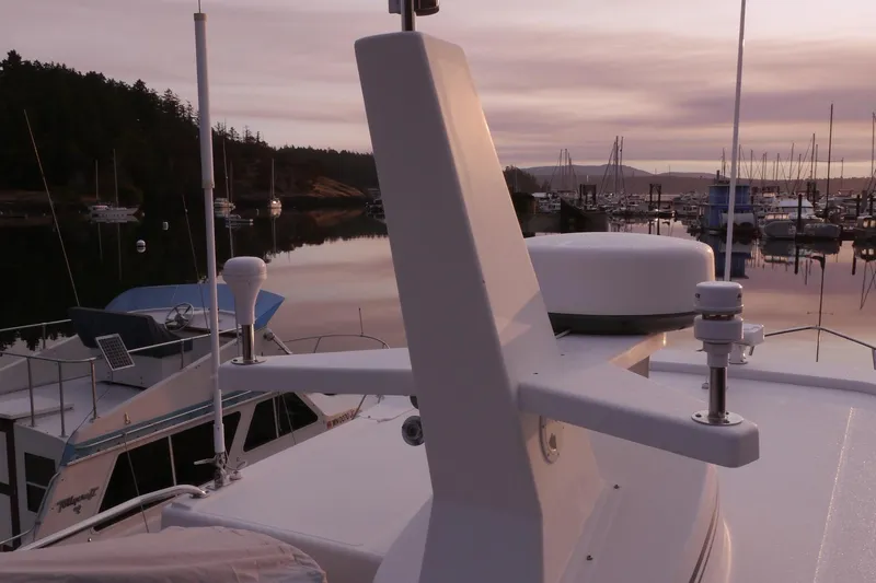 Slide: The Image of 2013 American Tug 395 at marina during sunset, with calm waters and docked boats. - 116