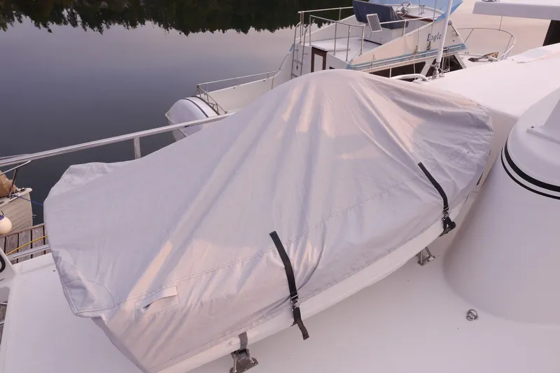Slide: The Image of Covered boat on American Tug 395, 2013 model, docked on calm water. - 118
