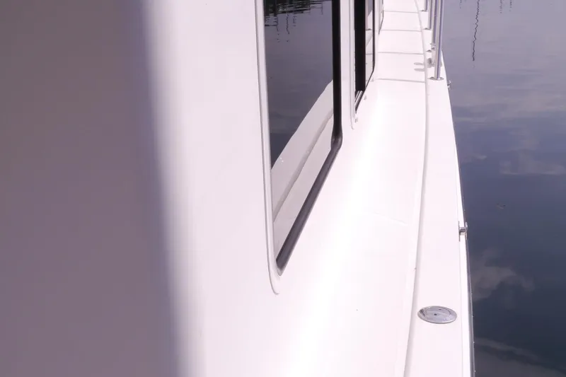 Slide: The Image of Side view of a 2013 American Tug 395 boat on calm water. - 119