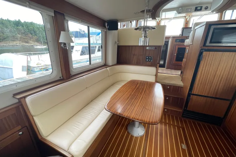 Slide: The Image of Interior of 2013 American Tug 395 with wood accents and cream seating. - 13