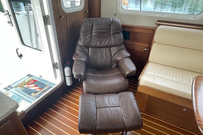 Slide: The Image of Luxurious interior of 2013 American Tug 395 with leather recliner and wooden flooring. - 14