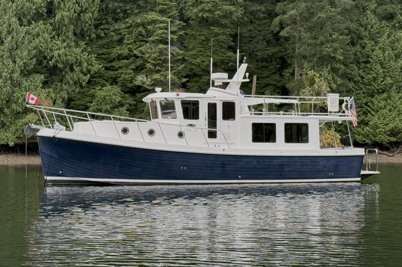 Slide: The Image of American Tug 395, 2013 model, cruising on a serene forest-lined waterway. - 2