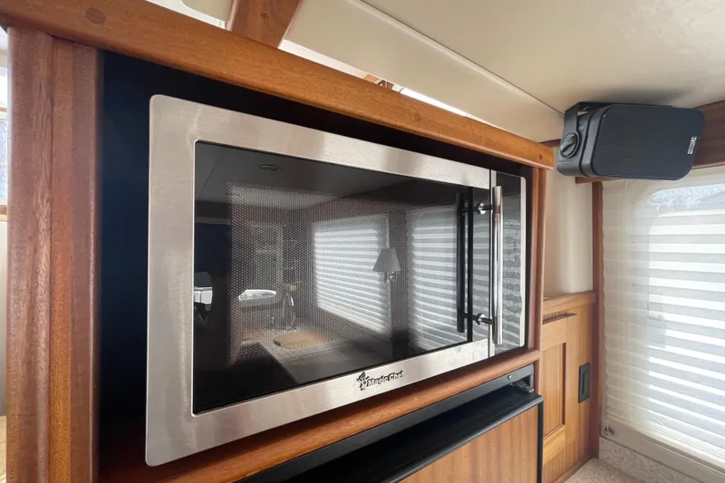 Slide: The Image of Microwave in 2013 American Tug 395 interior with wood accents and speaker. - 25