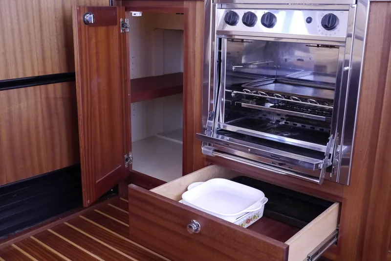 Slide: The Image of Interior of 2013 American Tug 395 showing kitchen oven and wooden cabinetry. - 27