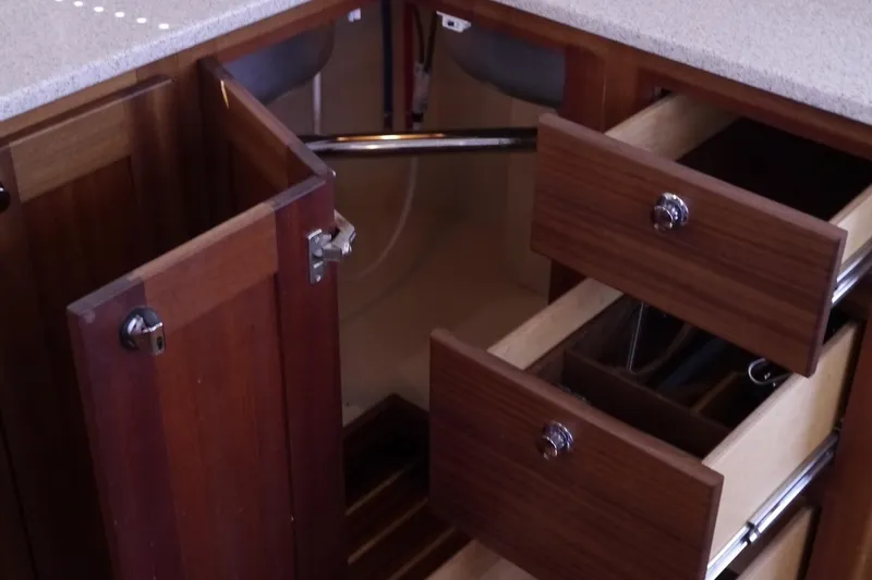 Slide: The Image of Interior view of 2013 American Tug 395 showing open wooden cabinets and drawers. - 31