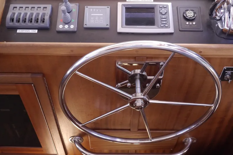 Slide: The Image of Steering wheel and control panel of 2013 American Tug 395 boat. - 36