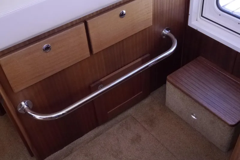 Slide: The Image of Interior of 2013 American Tug 395 with wooden cabinetry and metal handrail. - 40