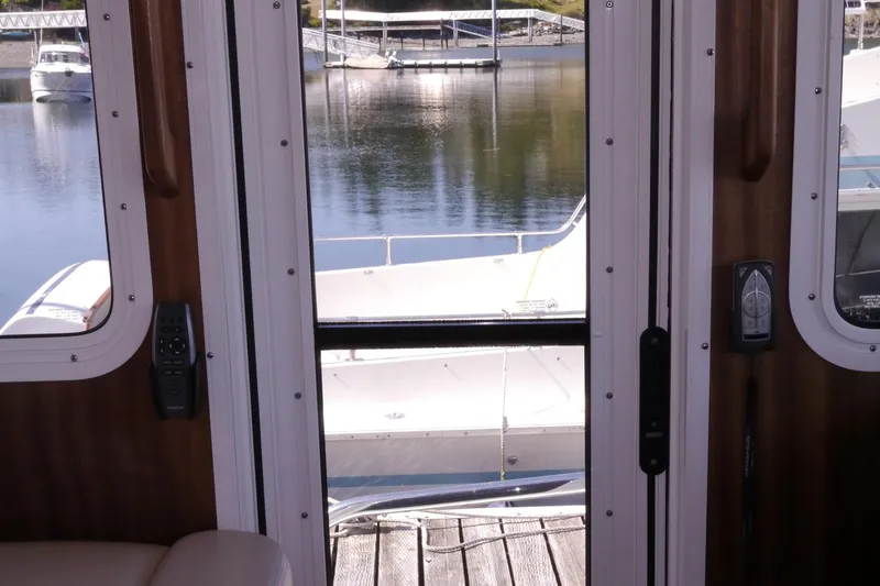 Slide: The Image of Interior view from American Tug 395, 2013, overlooking marina through glass doors. - 41