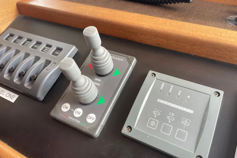 Slide: The Image of Control panel of a 2013 American Tug 395 with switches and joysticks. - 44