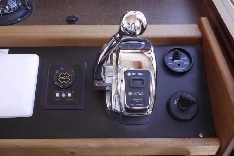 Slide: The Image of Control panel of a 2013 American Tug 395 boat with throttle and switches. - 47