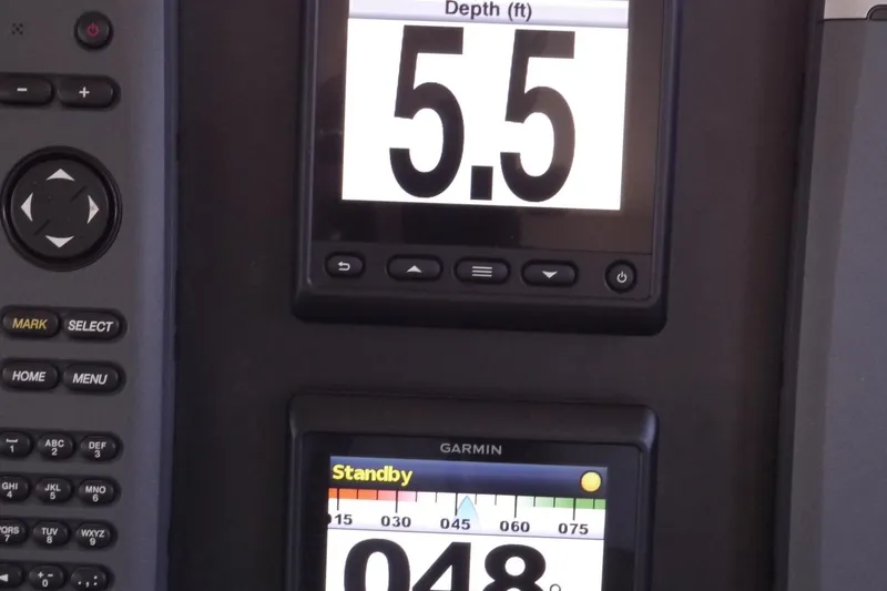 Slide: The Image of Control panel of a 2013 American Tug 395 displaying depth and navigation data. - 49