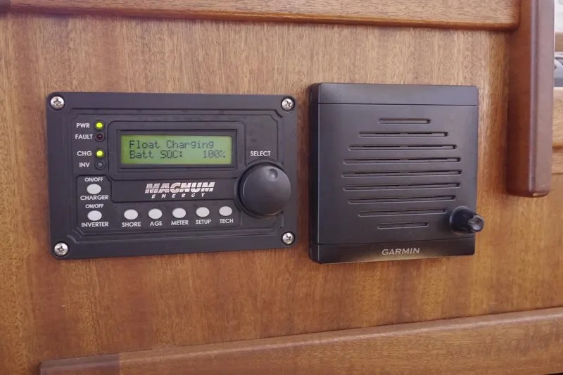 Slide: The Image of Control panel on 2013 American Tug 395, featuring Magnum Energy and Garmin devices. - 50