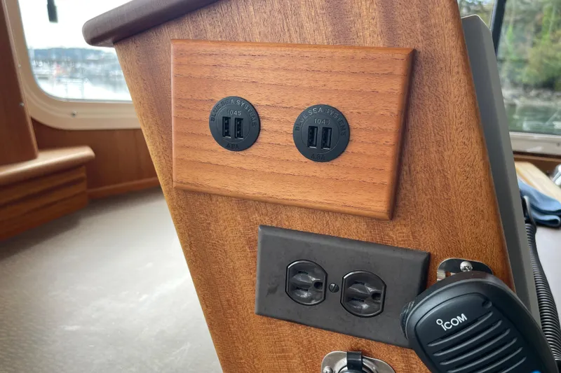 Slide: The Image of Control panel with USB ports and outlets on 2013 American Tug 395 boat. - 51