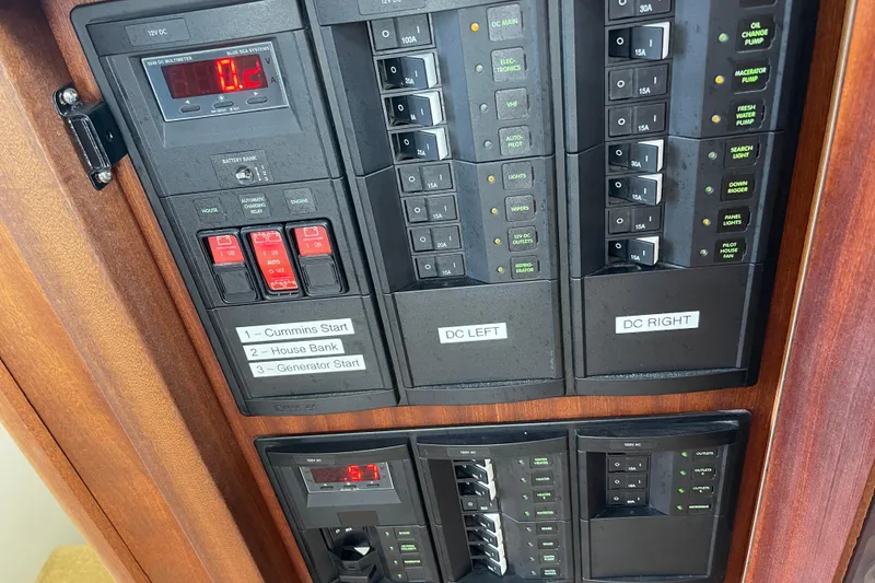 Slide: The Image of Electrical panel of a 2013 American Tug 395 boat, featuring various switches and controls. - 53