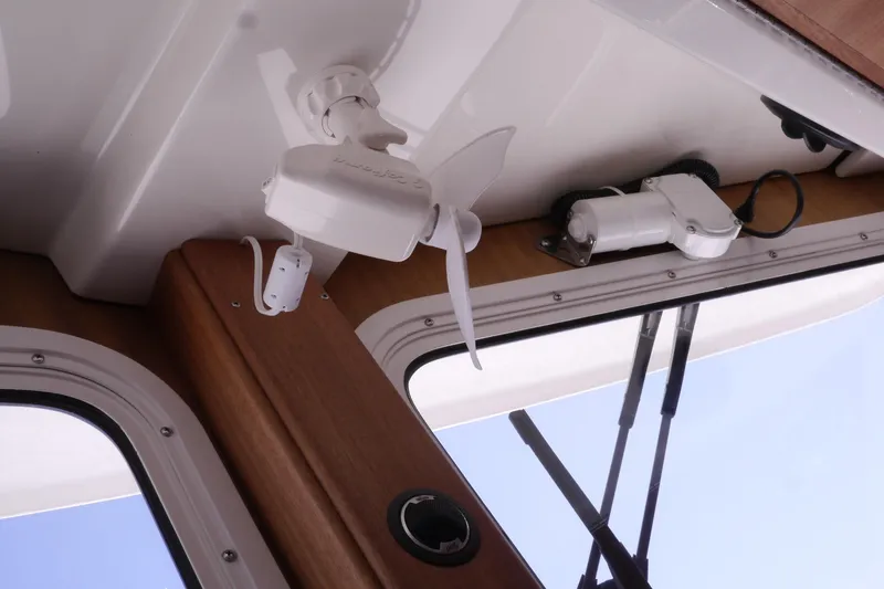 Slide: The Image of Interior view of 2013 American Tug 395, showcasing ceiling-mounted equipment and window details. - 55