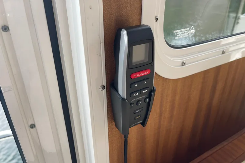 Slide: The Image of Control panel on 2013 American Tug 395 boat, mounted on wooden interior wall. - 58