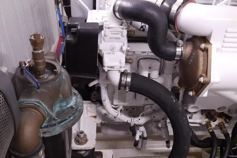 Slide: The Image of Engine compartment of a 2013 American Tug 395, showcasing hoses and mechanical components. - 71