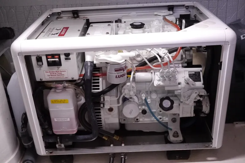 Slide: The Image of Engine compartment of a 2013 American Tug 395, showcasing mechanical components and wiring. - 73
