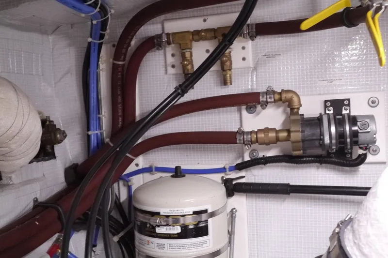 Slide: The Image of Engine room of 2013 American Tug 395 with pipes and mechanical components. - 76