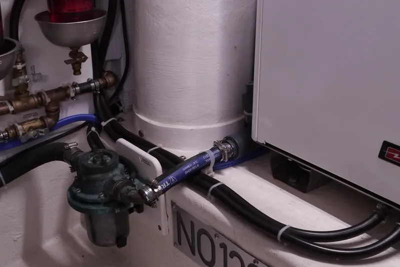 Slide: The Image of Engine room of 2013 American Tug 395 with visible plumbing and equipment. - 77