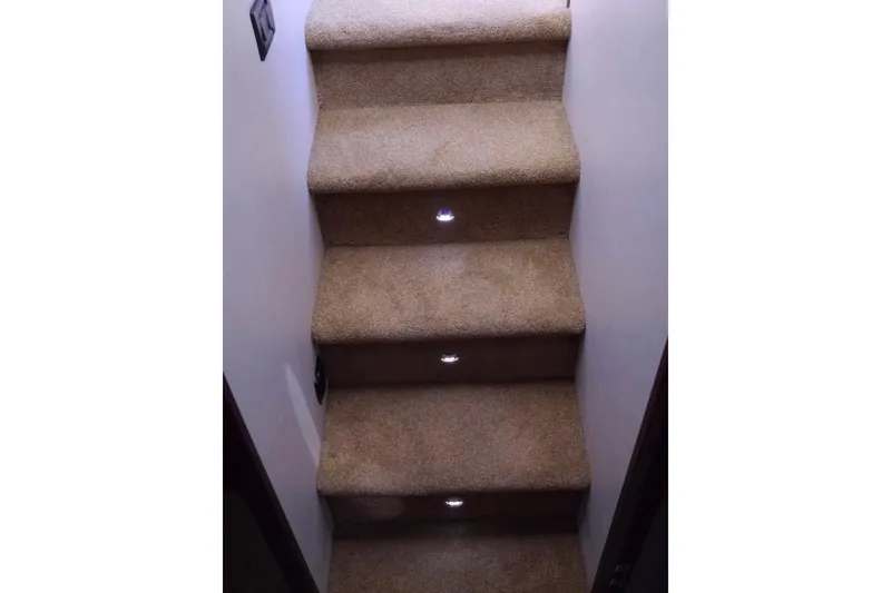 Slide: The Image of Carpeted stairs with built-in lights on a 2013 American Tug 395 boat. - 86