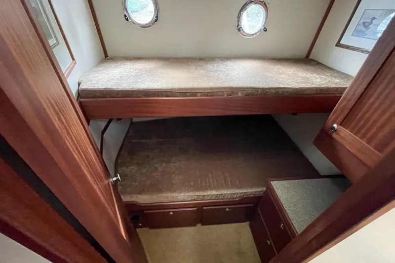 Slide: The Image of 2013 American Tug 395 cabin with bunk beds and portholes. - 87