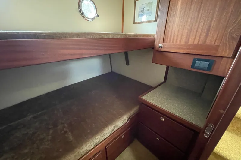 Slide: The Image of Cabin interior of 2013 American Tug 395 with wooden bunk and storage. - 88