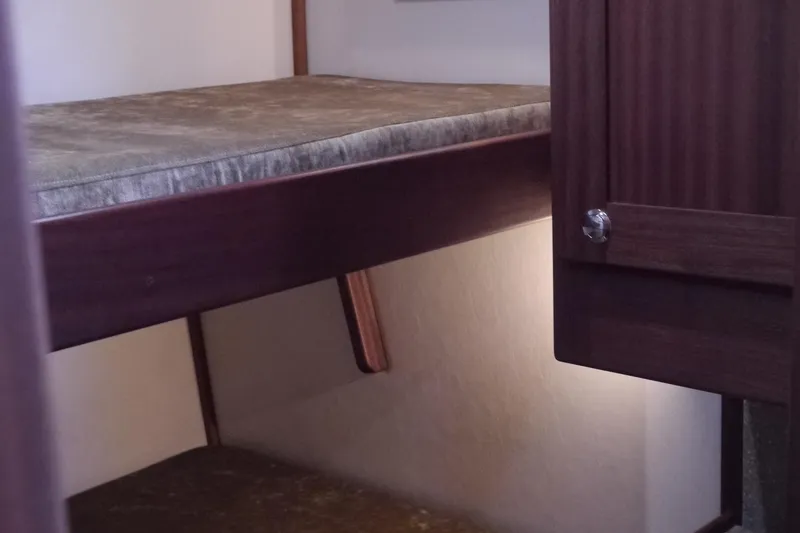 Slide: The Image of Interior cabin of 2013 American Tug 395 with bunk bed and wooden cabinetry. - 89