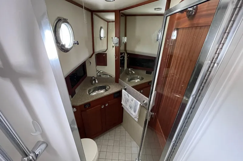 Slide: The Image of Bathroom interior of 2013 American Tug 395 with sink, mirror, and shower. - 91