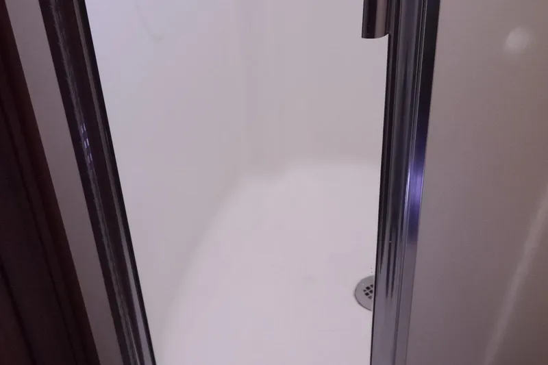 Slide: The Image of Shower area inside 2013 American Tug 395 boat, featuring a sleek design. - 92