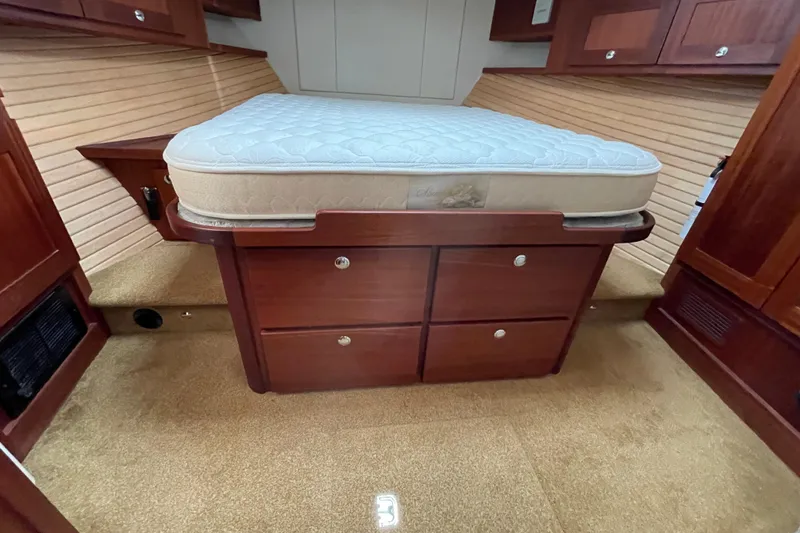 Slide: The Image of Cozy cabin interior of 2013 American Tug 395 with wooden storage and comfortable mattress. - 97