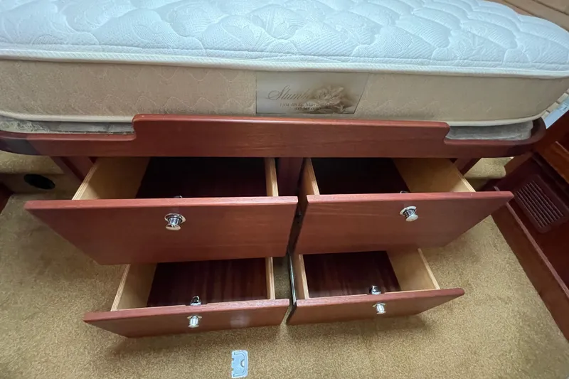 Slide: The Image of Under-bed storage drawers in a 2013 American Tug 395 boat cabin. - 98