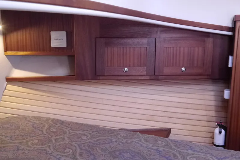 Slide: The Image of Interior of 2013 American Tug 395 with wooden cabinets and patterned bedding. - 99
