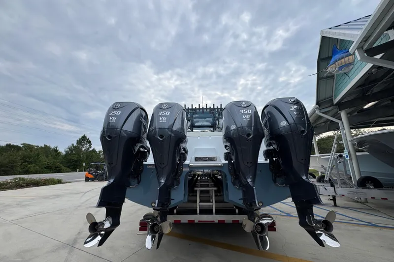 Slide: The Image of 2026 Invincible 38 Catamaran with four powerful outboard engines, docked under cloudy skies. - 14