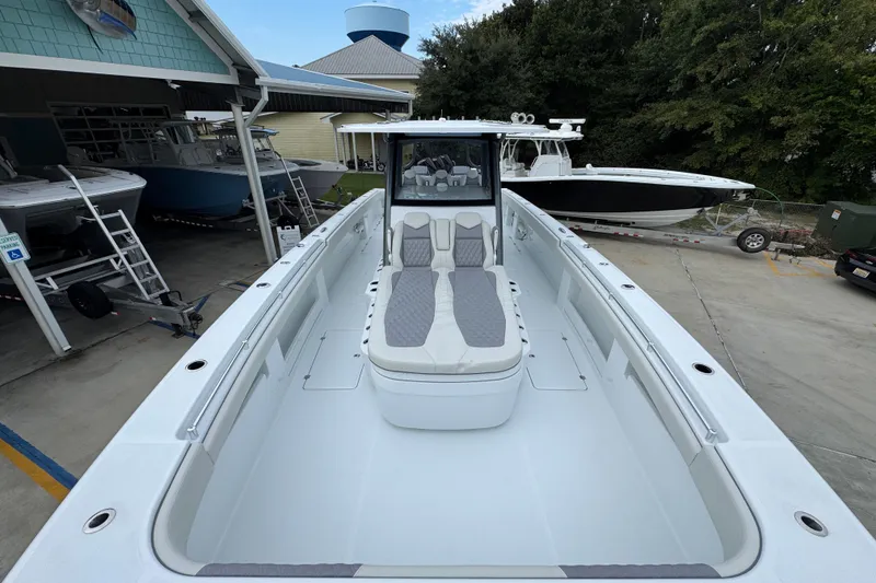 Slide: The Image of 2026 Invincible 38 Catamaran with sleek design, docked at a marina. - 22