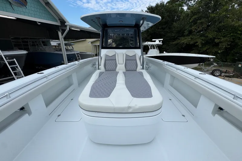 Slide: The Image of 2026 Invincible 38 Catamaran with sleek deck and comfortable seating, docked outdoors. - 23