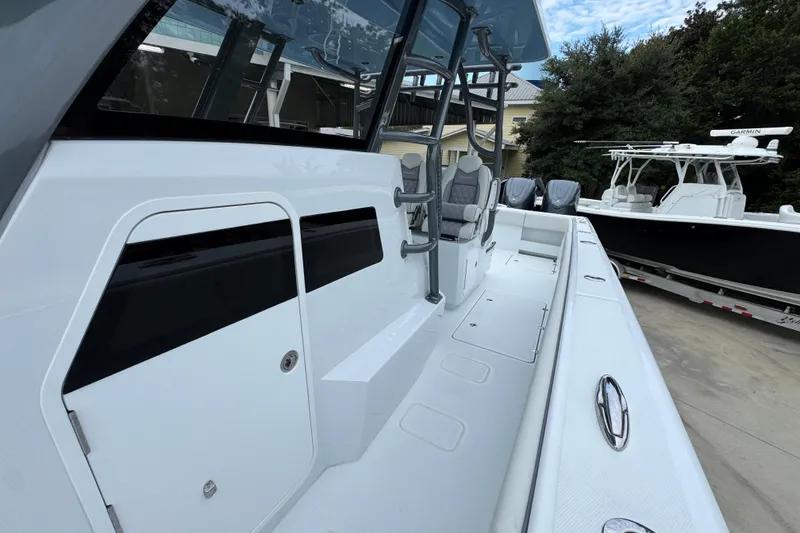 Slide: The Image of 2026 Invincible 38 Catamaran with sleek design and modern features, docked outdoors. - 24