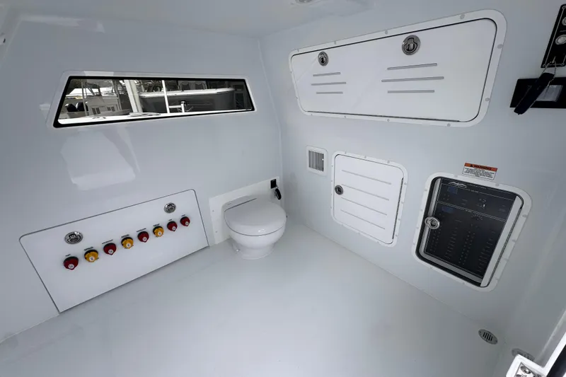 Slide: The Image of Interior of 2026 Invincible 38 Catamaran featuring control panel and marine toilet. - 26